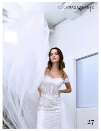 a woman in a white dress is posing with a veil