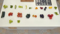 a kitchen counter with a variety of vegetables on it