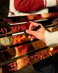 a person writing on a bench