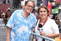 a man and woman posing for a photo in times square