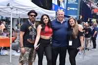 a group of people posing for a photo in times square