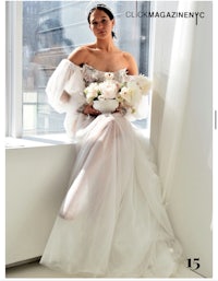 a woman in a wedding dress sitting on a window sill