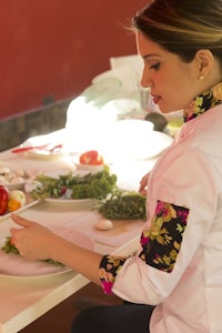 a woman is preparing food on a table