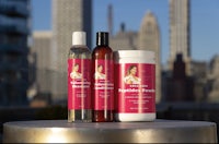 a bottle of hair care products in front of a city skyline