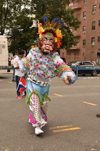 a man in a colorful costume walking down the street