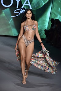 a model in a bikini walks the runway at miami fashion week