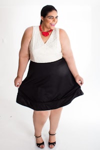 a plus size woman wearing a black and white skirt