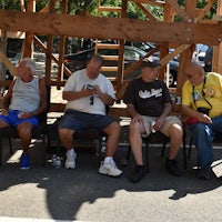 a group of men sitting on chairs