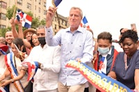 a group of people holding flags in front of a crowd