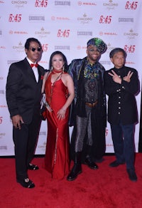 a group of people posing on a red carpet