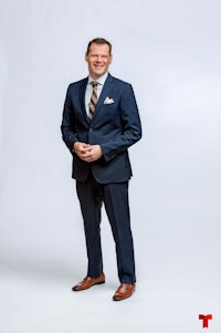 a man in a suit posing for a photo