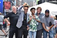 a group of people posing for a photo in times square