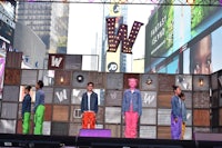 a group of people on a stage in times square