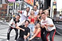 a group of people posing for a photo in times square