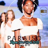 a woman in a bikini walks down the runway at pariso fashion week