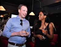 a man and a woman talking at a bar