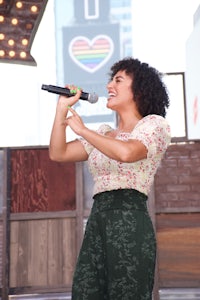 a woman singing into a microphone