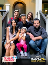 a group of people posing on the steps of a house