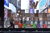 a group of boys on stage in times square