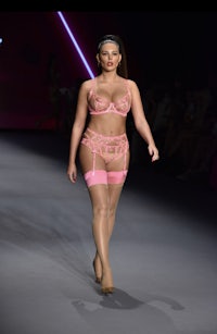 a model walks down the runway in pink lingeries