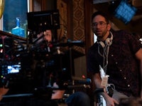 a man with headphones is on the set of a movie