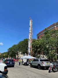 a tall tower with a lot of cars parked in front of it