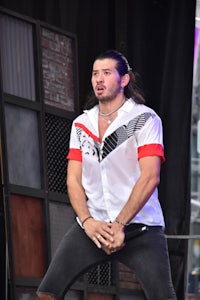 a man in a white shirt is standing on a stage