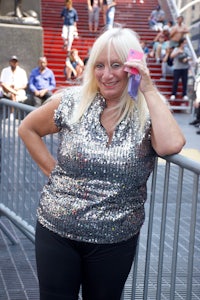 a woman wearing a silver top