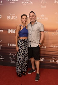 a man and woman standing on a red carpet