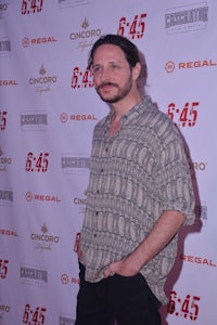 a man standing on a red carpet