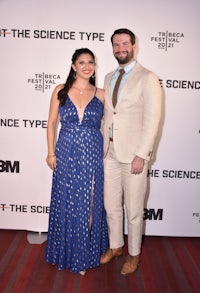 a man and woman posing for a photo on the red carpet