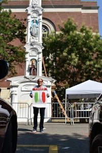 a man holding a sign in front of a church