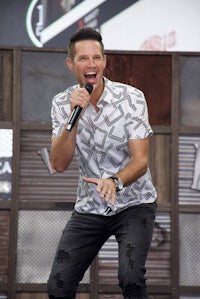 a man is singing into a microphone