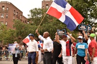 a group of people holding a dominican flag