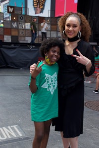 a woman and a girl posing for a picture