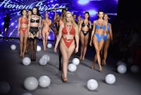 a group of women in bikinis on a runway