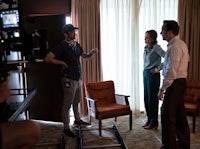 a group of people standing in a room with a camera