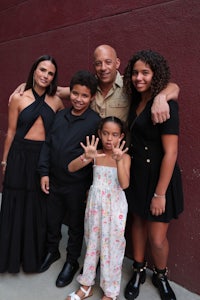 a family posing for a picture in front of a wall