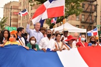 a group of people holding a dominican flag