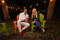 a man and a woman sitting on lawn chairs