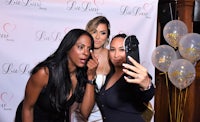 three women posing for a photo at a party