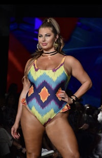 a model in a colorful swimsuit on the runway