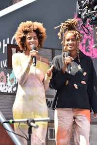 two women with dreadlocks standing next to each other