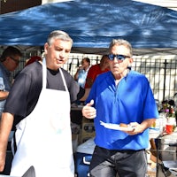 a man wearing a blue apron