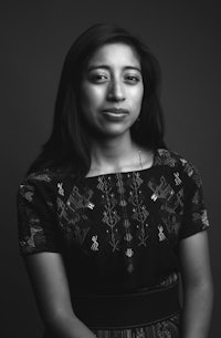 a black and white photo of a woman in a dress