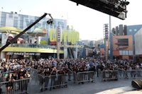 a crowd of people standing in front of a stage