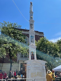 a statue of a clock in front of a building