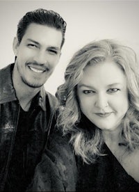 a black and white photo of a man and woman posing for a photo