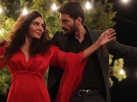 a man and woman dancing in a red dress