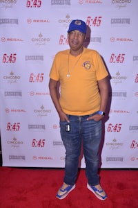 a man standing on a red carpet